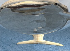 There is a 15 feet tall transparent  sphere. There is a cylinder 2 feet under the sphere. There is a very small light orange dolphin 6 feet above the cylinder. There is 6 feet tall and 12 feet wide shiny wood dolphin 0.001 feet under the dolphin. The ground is water. The white light  2 feet on the right of dolphin. The white light 1 feet in front 2 feet above the dolphin. There is 2 tiny dolphins on the right of the dolphin. There is 3 tiny dolphin on the left of the dolphin.