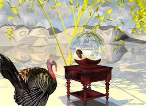 the  large silver bowling ball is on the table. the ground is shiny. a large orange illuminator is 4 feet above the ball. The table is under the very small yellow willow tree. The turkey is one foot in front of the table. the turkey is facing the ball. the tree is on the very tall  mountain range. 