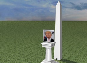 A [Trump] portrait is on a pedestal. The extremely tiny monument is 5 feet behind the portrait and on the ground. The ground is grass.