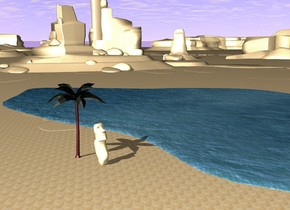 the ground is sand. there is water on the ground. there is a  small palm tree near the water. there is a statue in front of the plant.