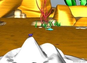 A blue cat is on top of a white mountain.  The sky is orange.  A fish is in the sky.