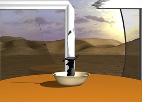 a bowl is on a table. a knife is in the bowl. There is a big window in front of the table.