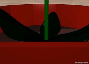 A flower is inside a pot. the ground is wood.