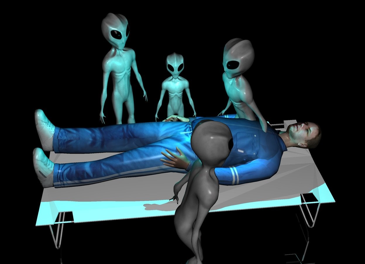 Input text: There is a bed. On the bed is a man. The man faces up. The man faces north. The man is -5 feet in the bed. On the left of the bed is an alien. There is a second alien on the right of the bed. The second alien faces the man. The second alien is 3 feet tall. Next to  the second alien is a third alien. The third alien faces the man. The third alien is in front of the  second alien. There is a fourth alien behind the second alien. The fourth alien faces the man. There is a cyan light above the man. It is night. The ground is shiny. The ground is black.