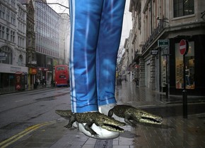 the city backdrop. the man is -4.5 inches above the  very tiny crocodiles. he is 6 feet tall. 
