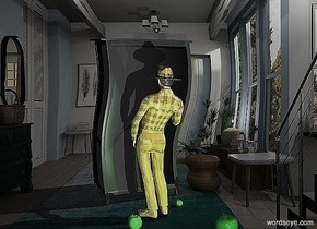 the man is behind a large dark wardrobe 
the man is shiny and golden

a green apple is next to the man

a light source is 3 meters behind the man 

a large green apple is behind the man to the right

a large green apple is 0.55 meters behind the man to the left

a green light source is 1 meter behind the wardrobe