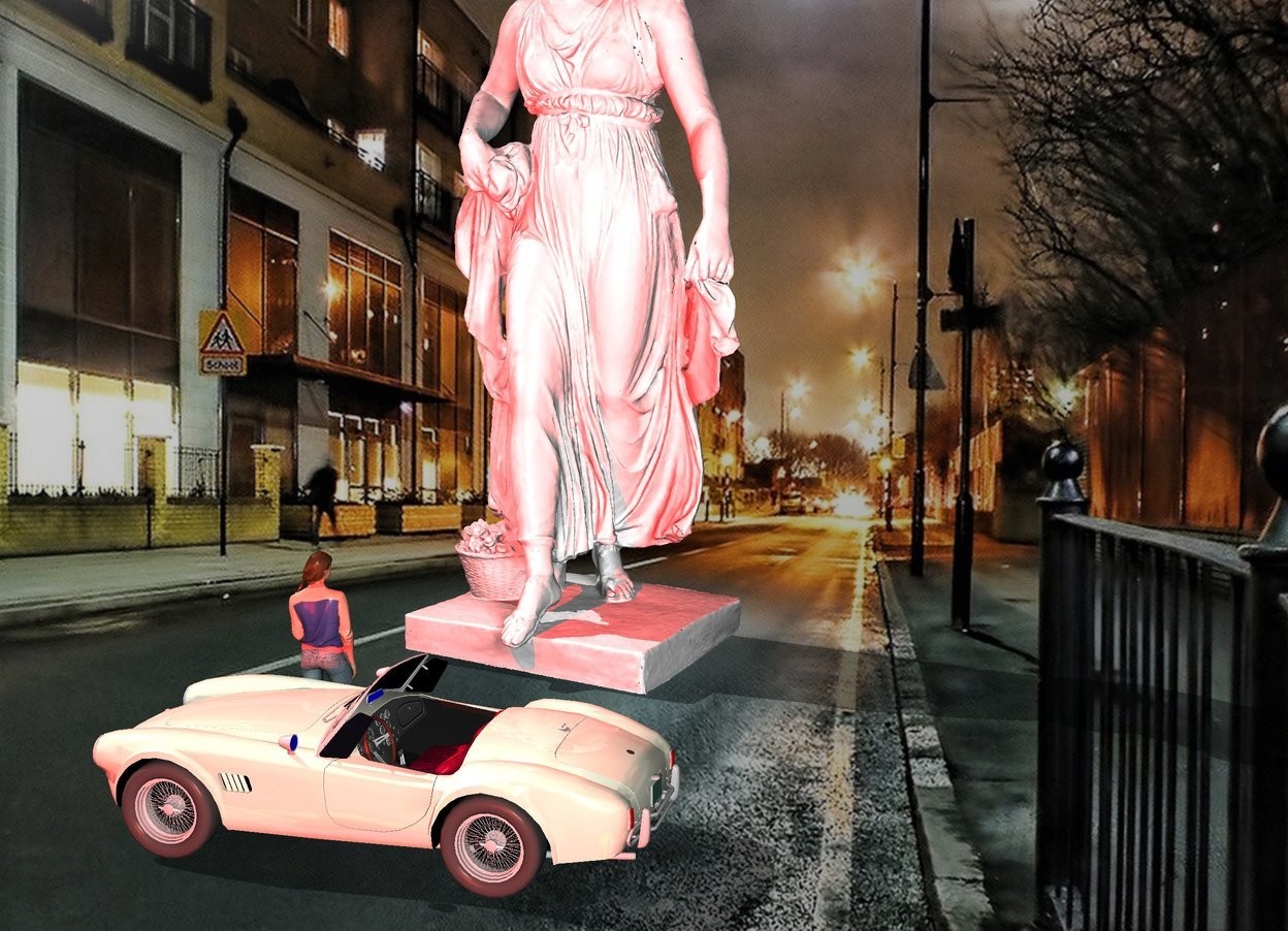 Input text: The large white statue is in the street. The small car is 4 feet in front of the statue. It is facing left. The small woman is behind and -2 feet to the left of the car. SHe is facing back. The red light is 1 foot above and behind the woman. A 2nd red light is 23 feet in front and above the car. 
